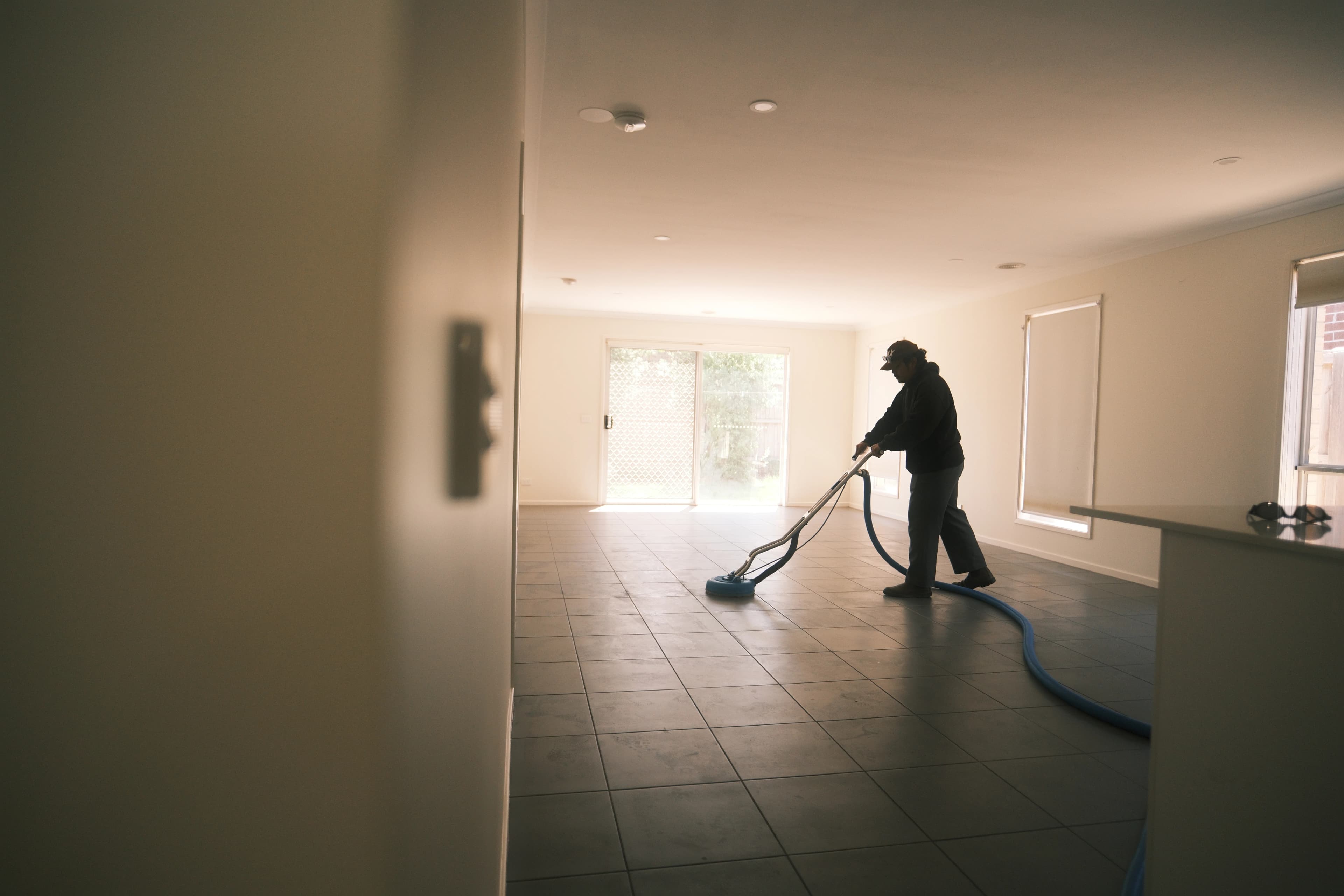 Nusara team member cleaning floors with professional equipment